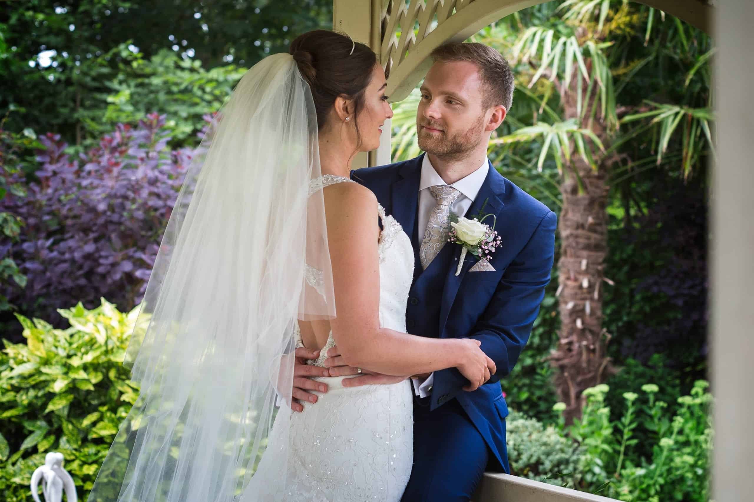 A couple embracing in a gazebo at Warwick House in Southam.
