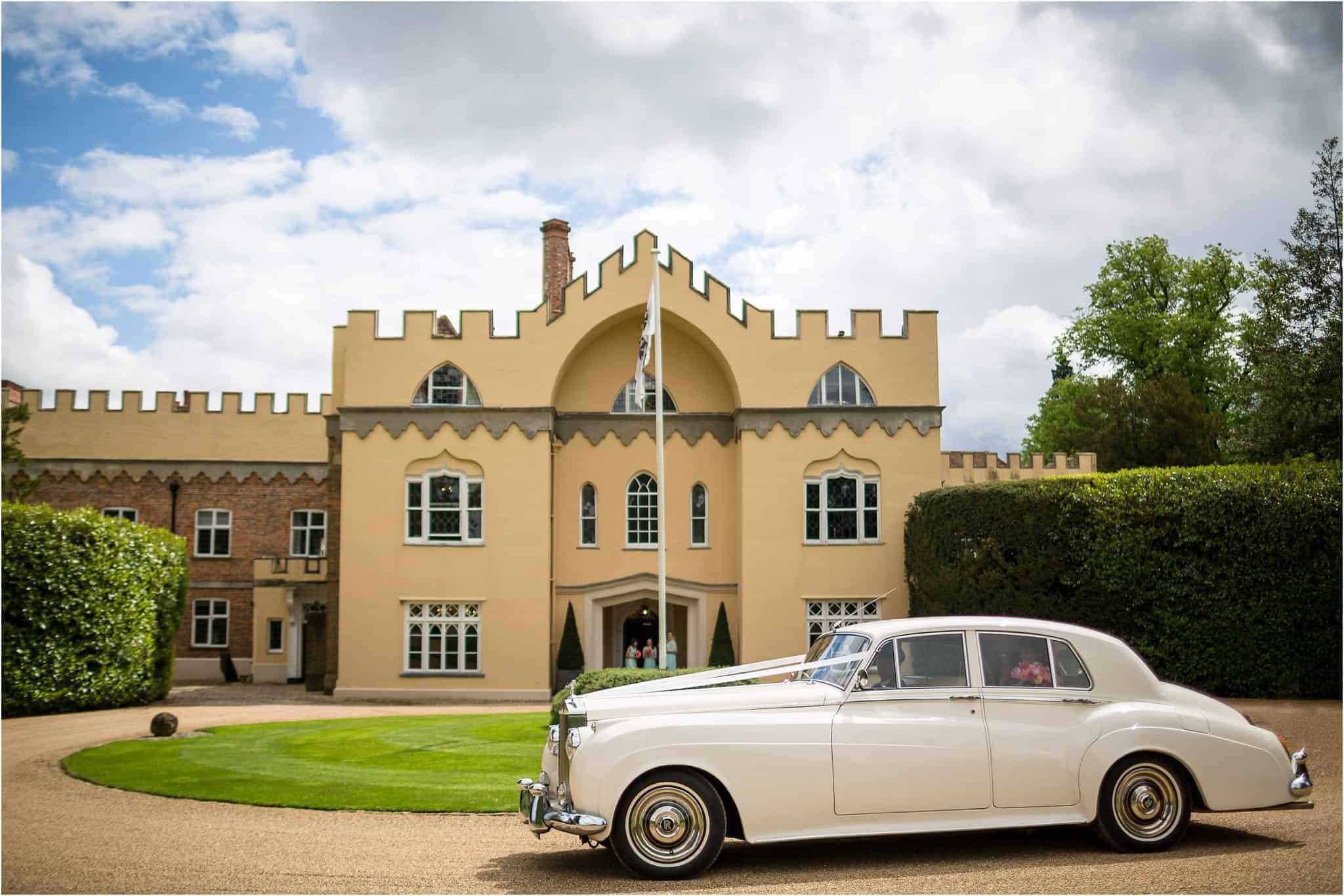 a photo of a vintage car pulling up to a grand venue. Image by S2 Images, Hampden House Wedding Photographer